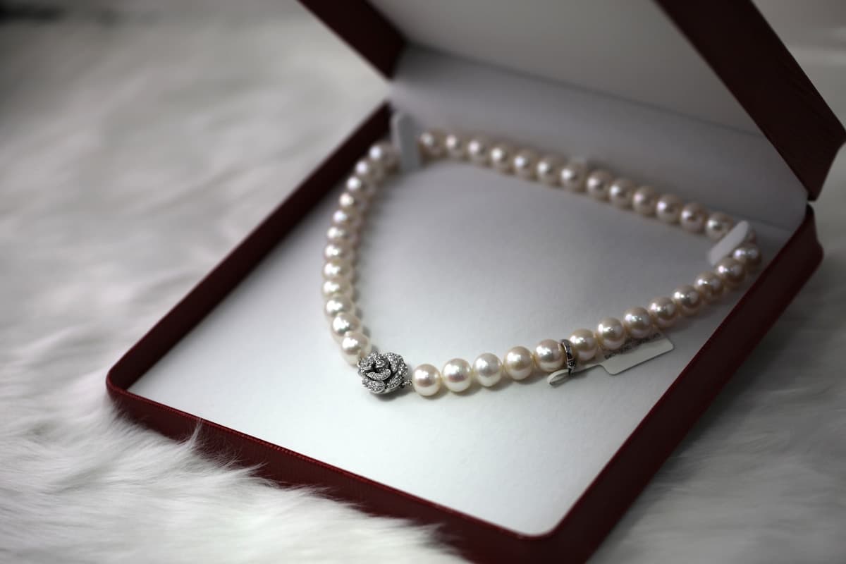 Ruby and gold jewellery detail on a light presentation surface